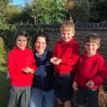 school children feeding birds